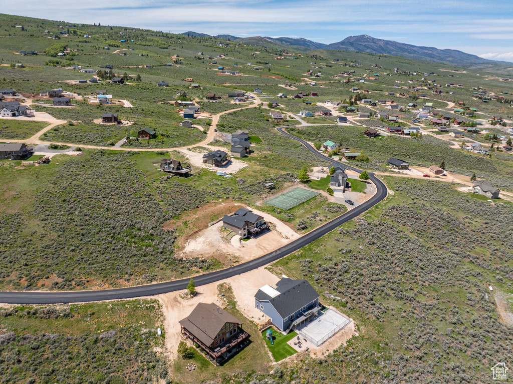 Aerial view of property and surrounding area featuring mountains