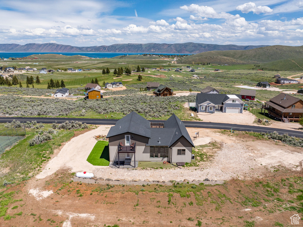 Aerial view of property and surrounding area featuring mountains
