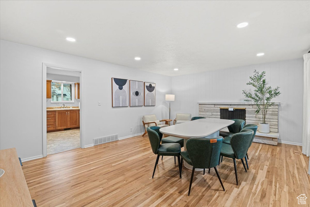 Dining area with sink and light hardwood / wood-style flooring