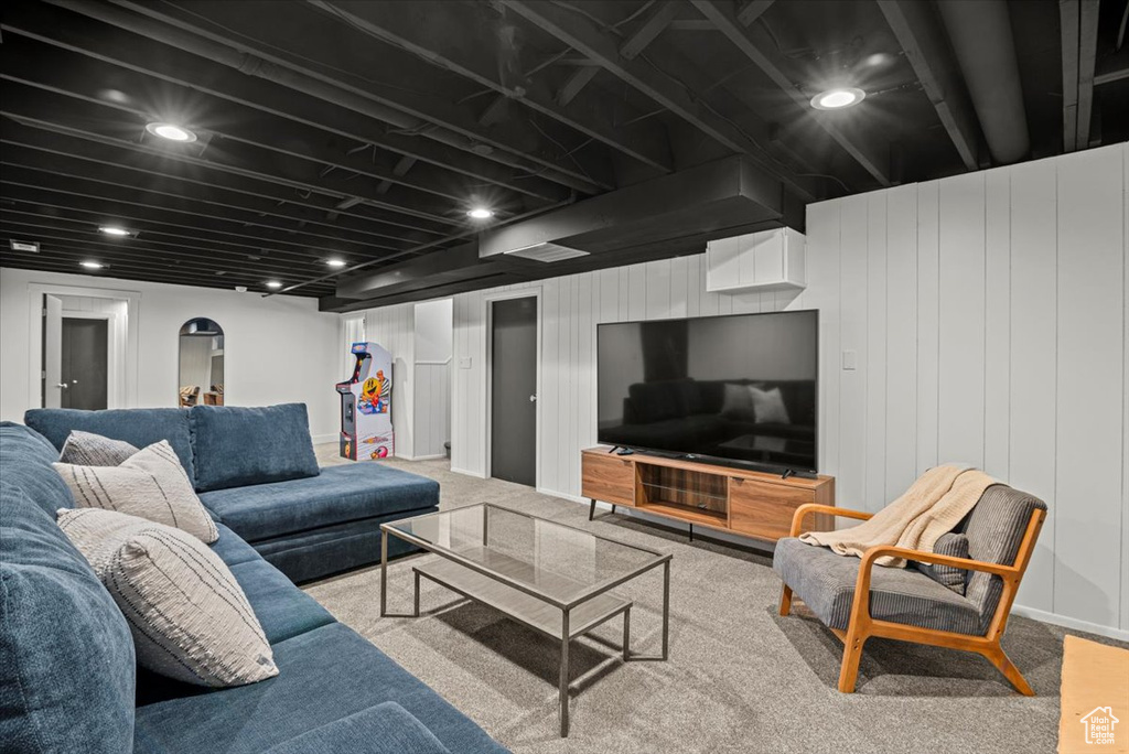 Living room with carpet flooring and wooden walls