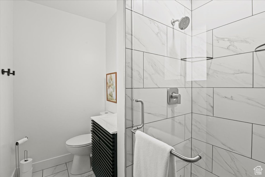 Bathroom featuring vanity, toilet, and an enclosed shower