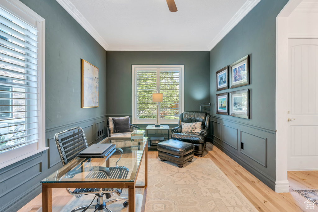 Sitting room featuring light hardwood / wood-style floors, ceiling fan, and ornamental molding