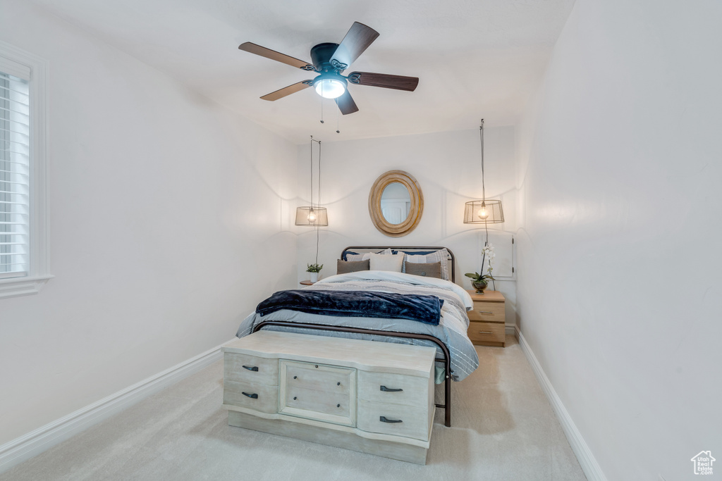 Carpeted bedroom with ceiling fan