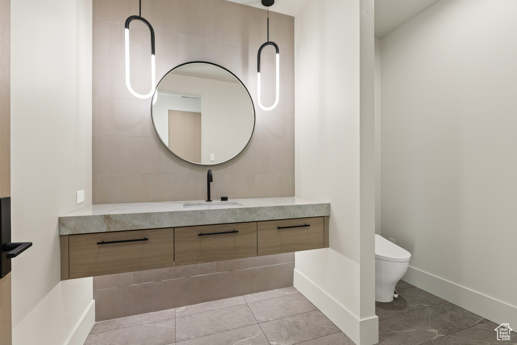 Bathroom with tile patterned flooring, vanity, and toilet