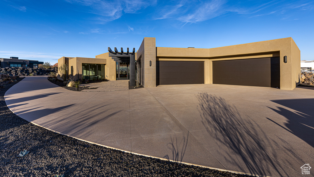 Pueblo-style house with a garage