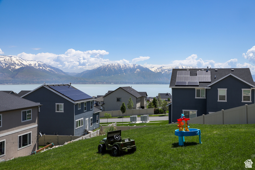 View of yard with central AC unit and a water and mountain view
