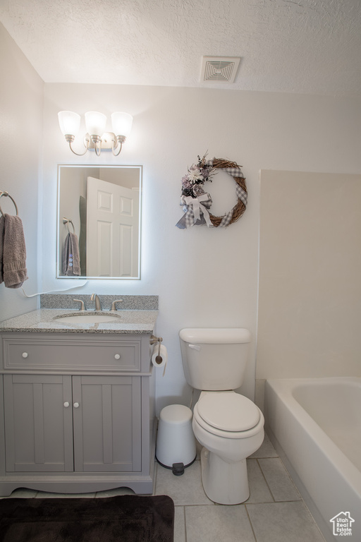 Full bathroom with visible vents, toilet, a tub, a textured ceiling, and tile patterned floors