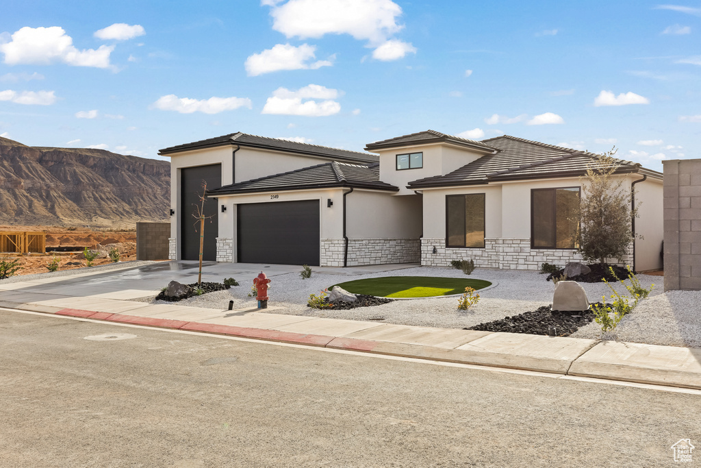 Prairie-style house featuring a mountain view and a garage