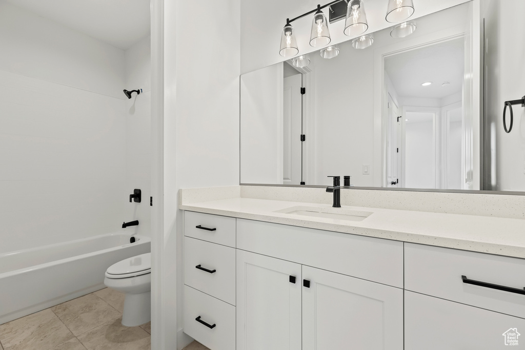 Full bathroom with tile patterned flooring, vanity, toilet, and shower / tub combination