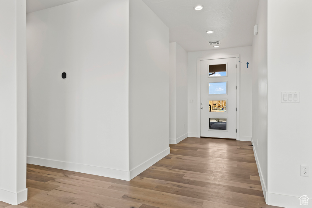 Corridor with light hardwood / wood-style floors