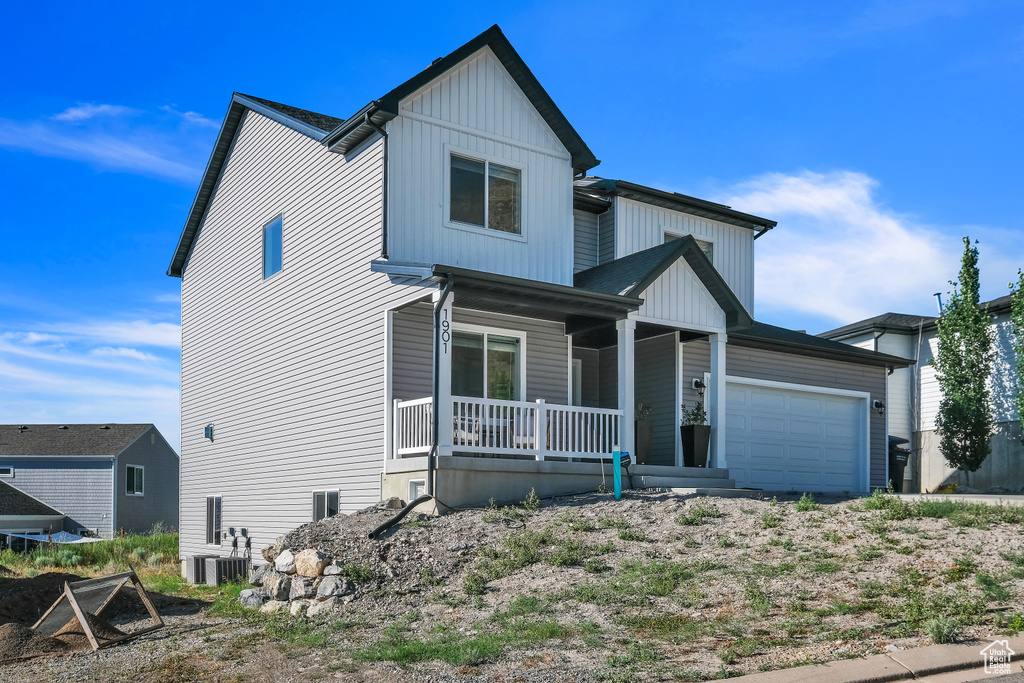 View of front of property featuring cooling unit and covered porch