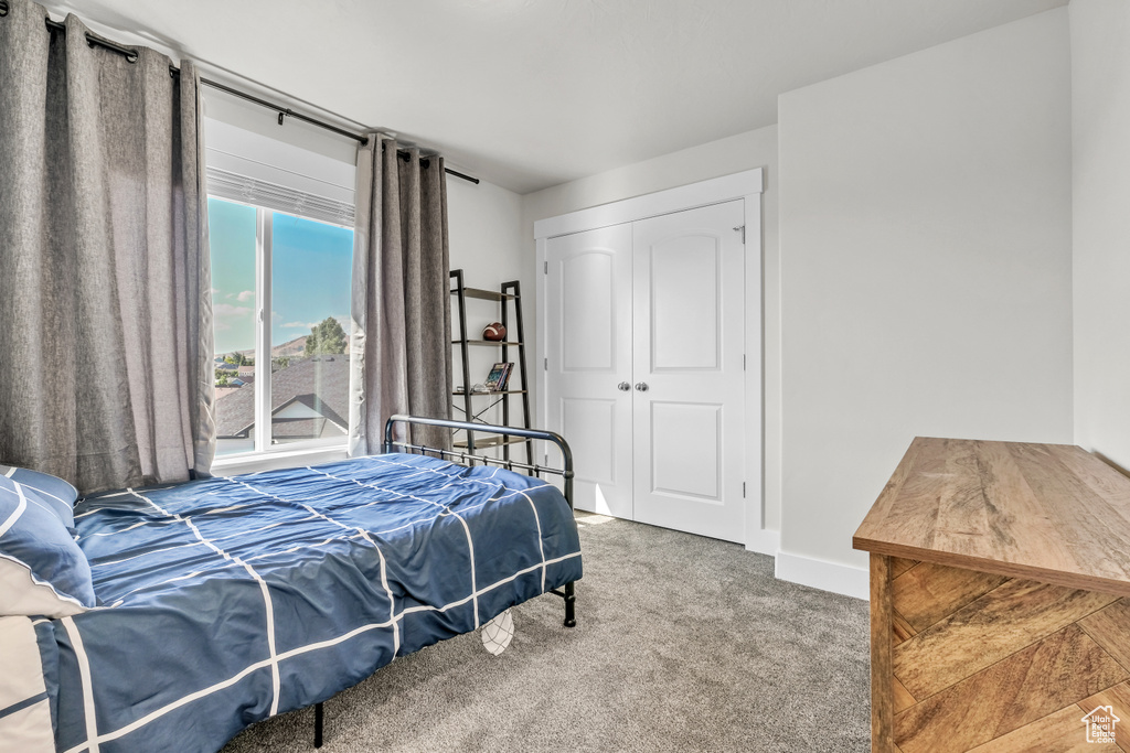 Bedroom with carpet and a closet