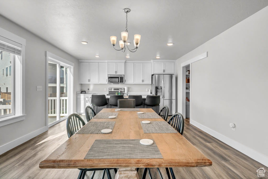 Dining space featuring light hardwood / wood-style flooring and a chandelier