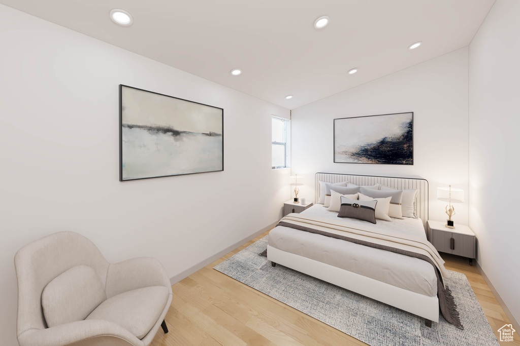 Bedroom with vaulted ceiling and light wood-type flooring