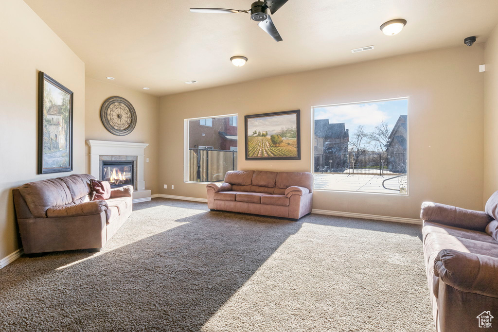 Living room with ceiling fan and carpet