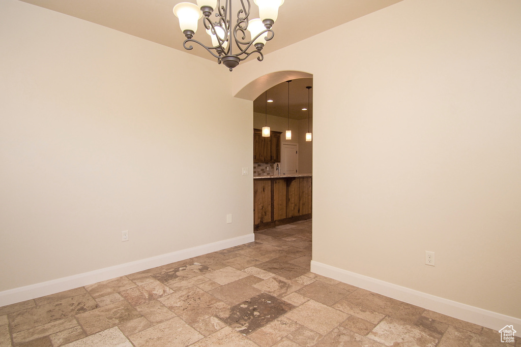Spare room featuring a chandelier