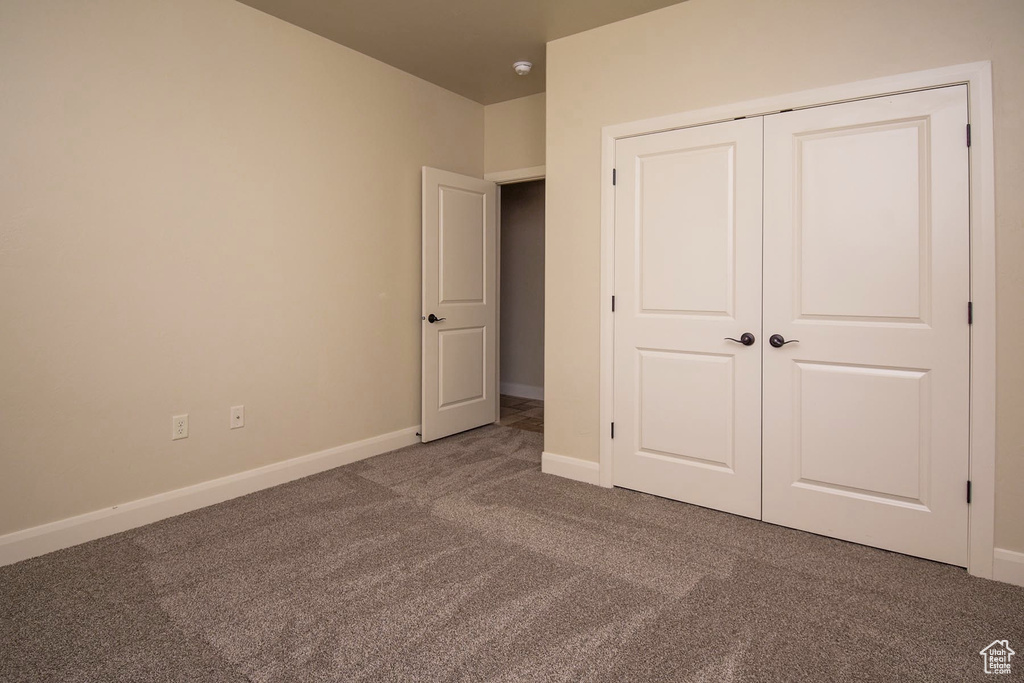 Unfurnished bedroom with carpet floors and a closet