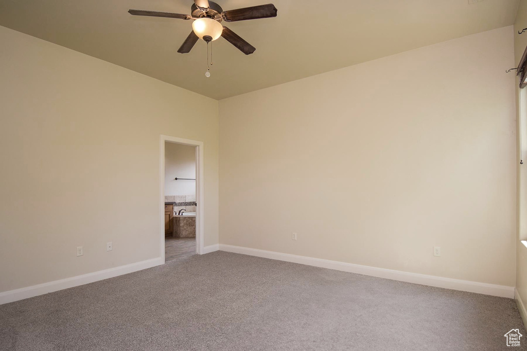 Unfurnished room with carpet and ceiling fan