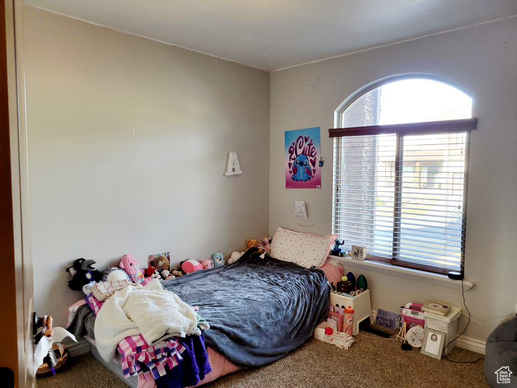 Bedroom with carpet floors and multiple windows