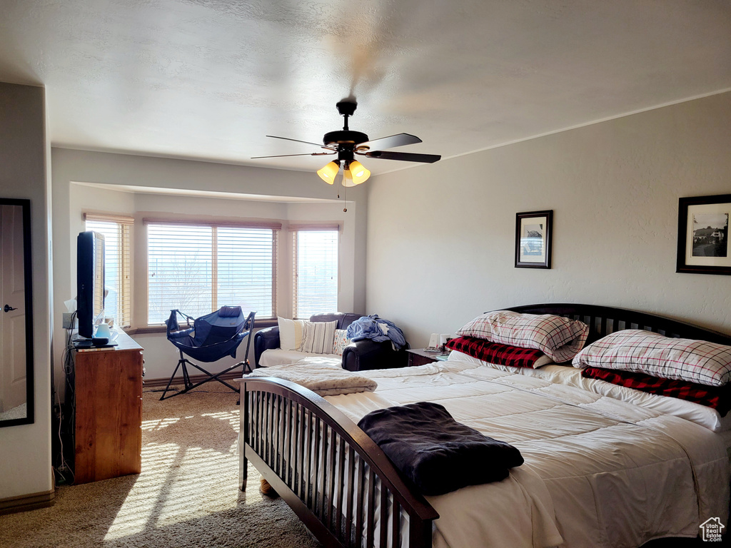 Bedroom featuring ceiling fan and light carpet