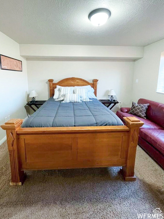 Carpeted bedroom featuring a textured ceiling