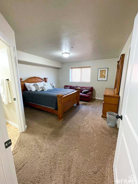 Carpeted bedroom with a textured ceiling