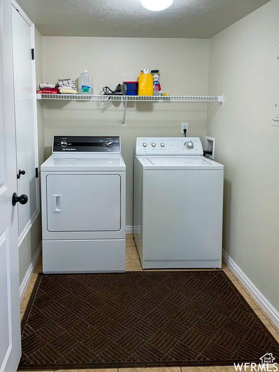 Laundry room with washer and clothes dryer