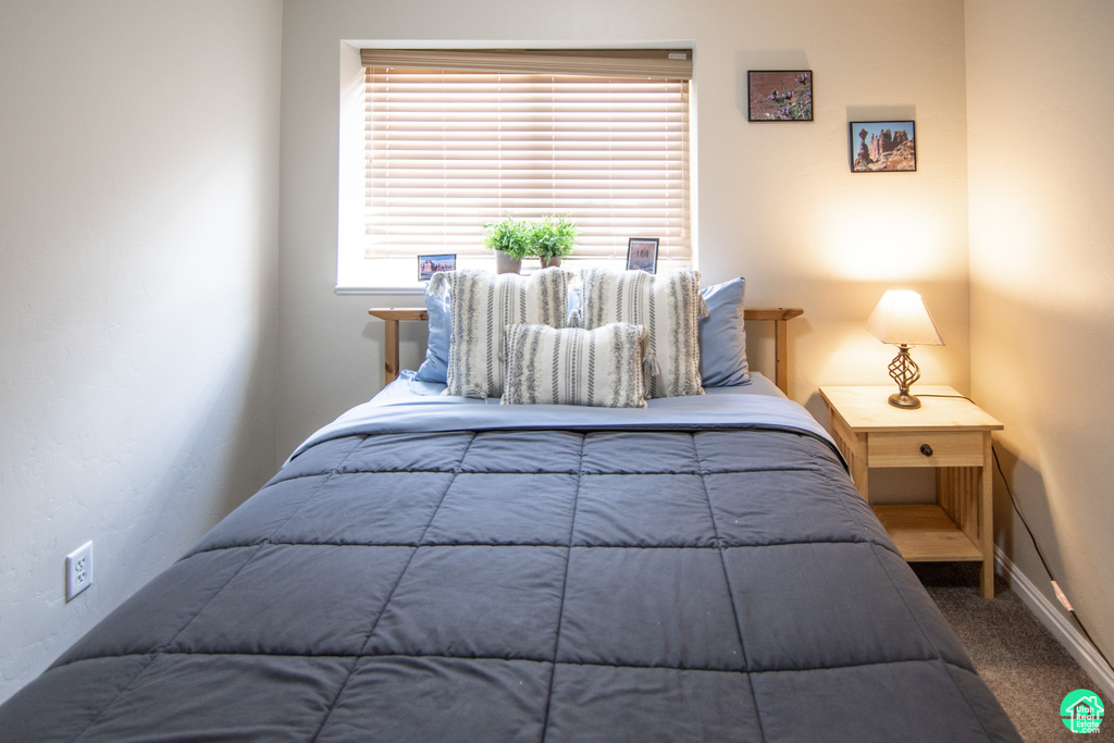 Bedroom with carpet and baseboards
