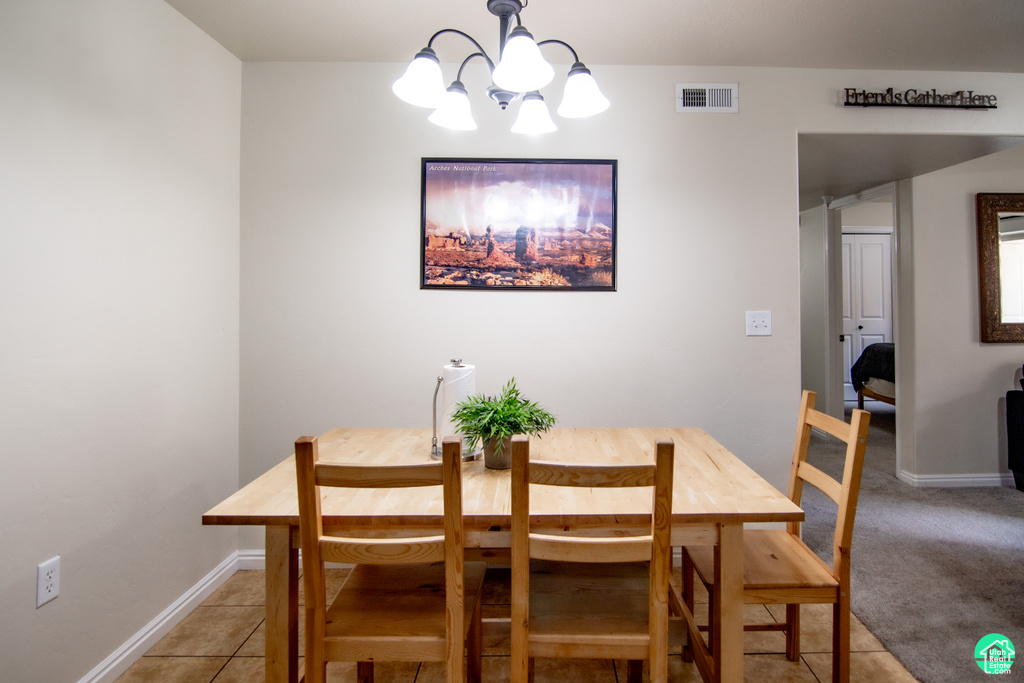 Dining space featuring a chandelier and baseboards