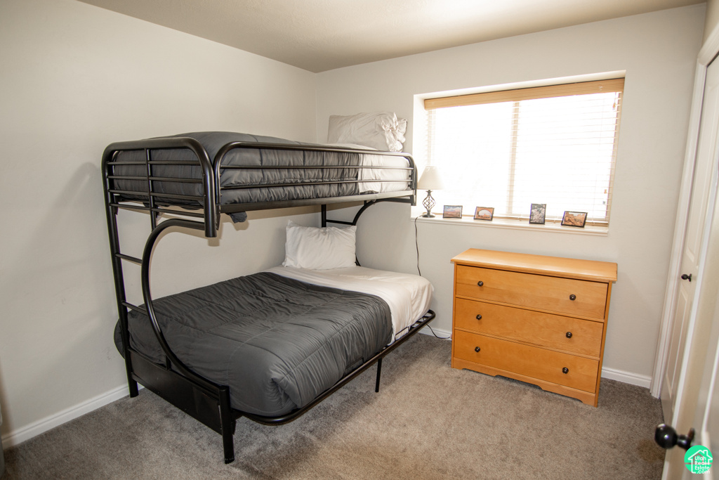 Carpeted bedroom with baseboards