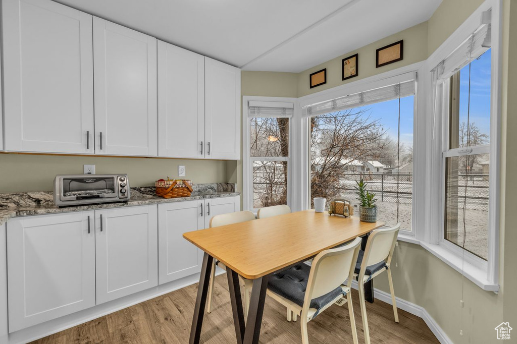 Dining area with light hardwood / wood-style floors