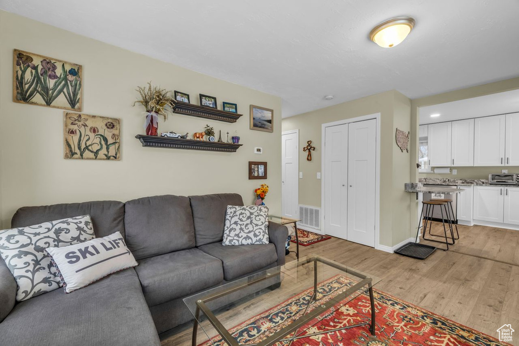 Living room with hardwood / wood-style flooring
