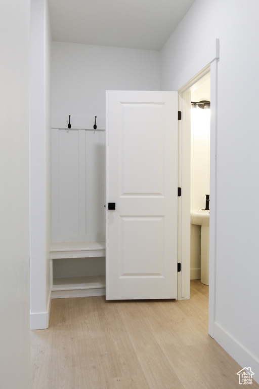 Mudroom with light wood-type flooring and baseboards