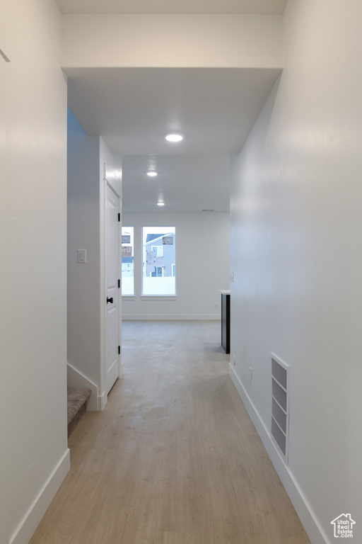 Hall featuring baseboards and light wood-style flooring