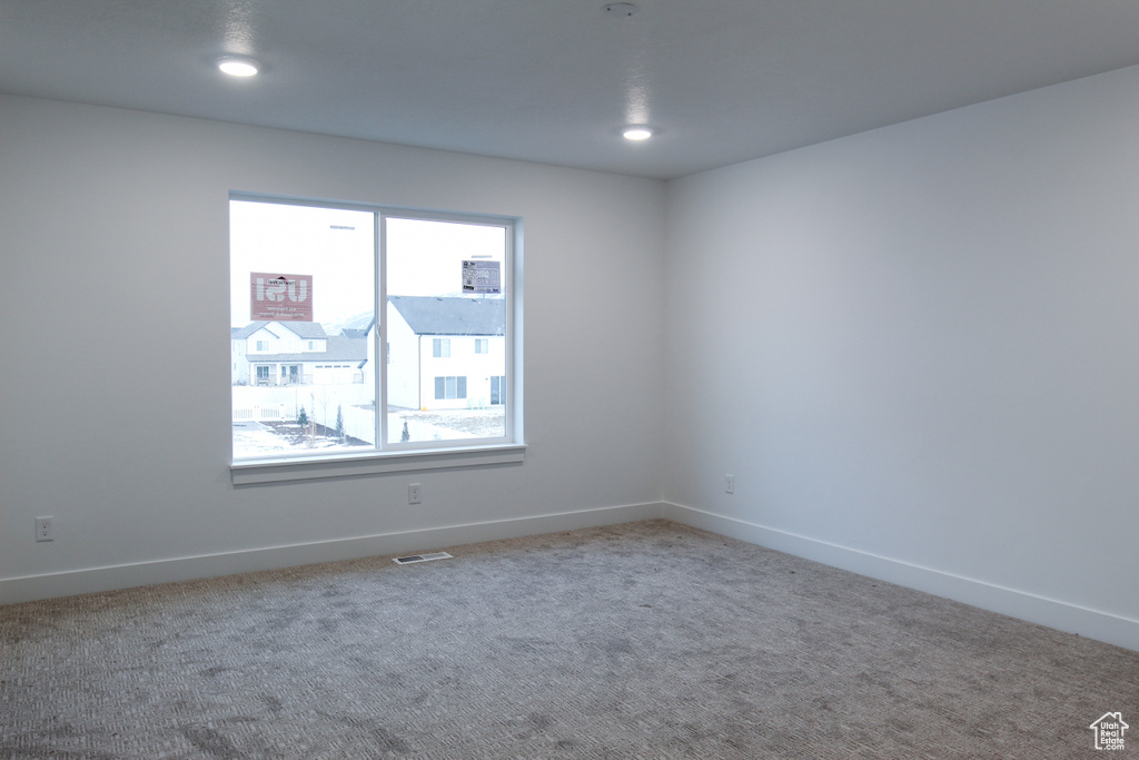 Unfurnished room featuring carpet, baseboards, and recessed lighting