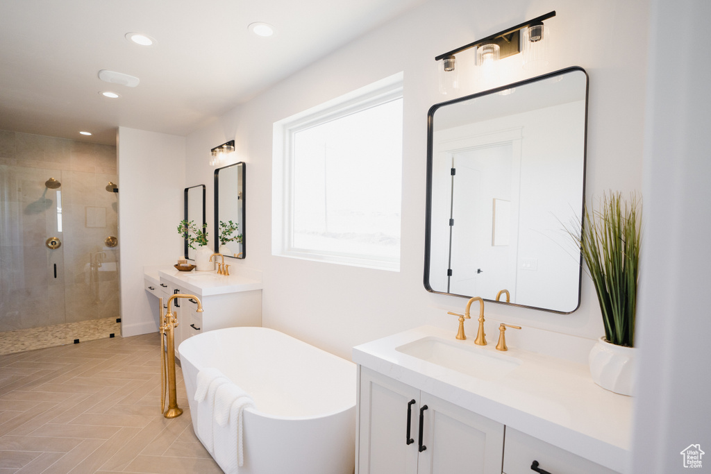 Bathroom with independent shower and bath, parquet floors, and vanity