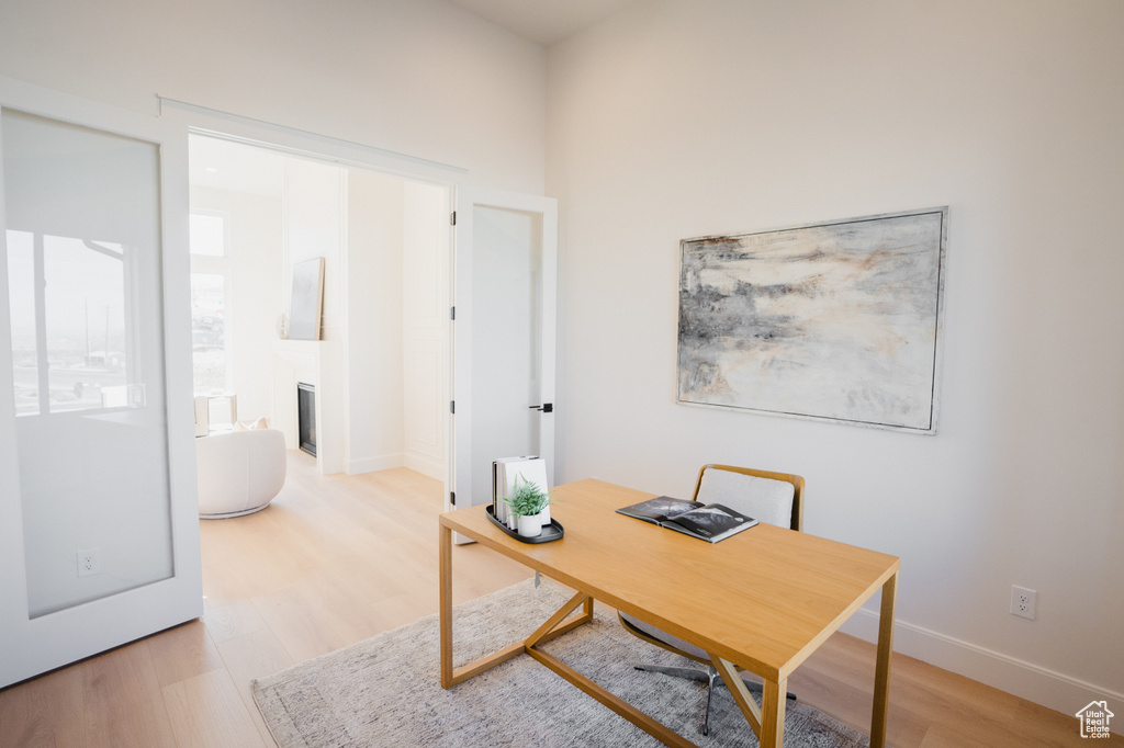 Office area with light hardwood / wood-style flooring