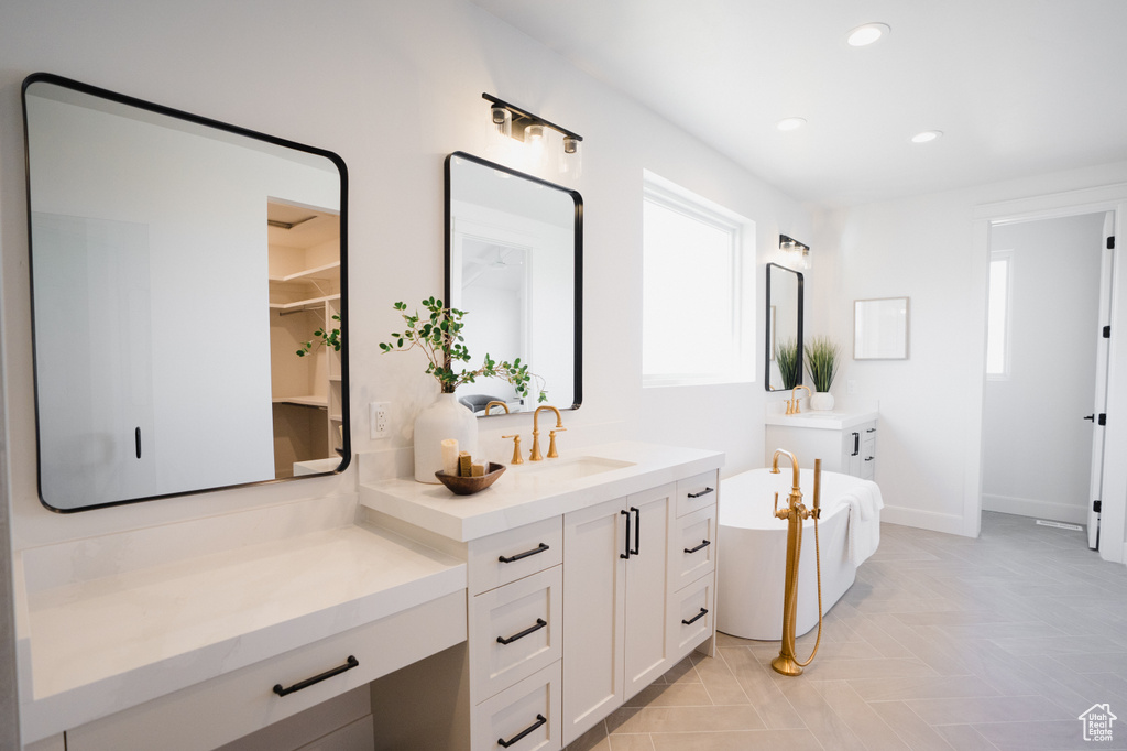 Bathroom featuring a bath and vanity