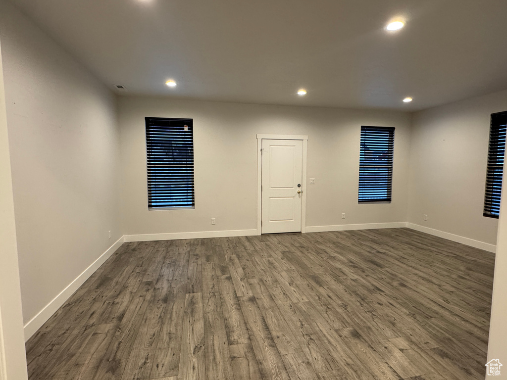 Empty room with dark wood-type flooring