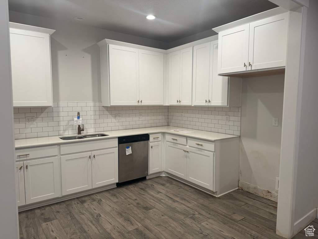 Kitchen featuring dark hardwood / wood-style flooring, white cabinetry, and dishwasher
