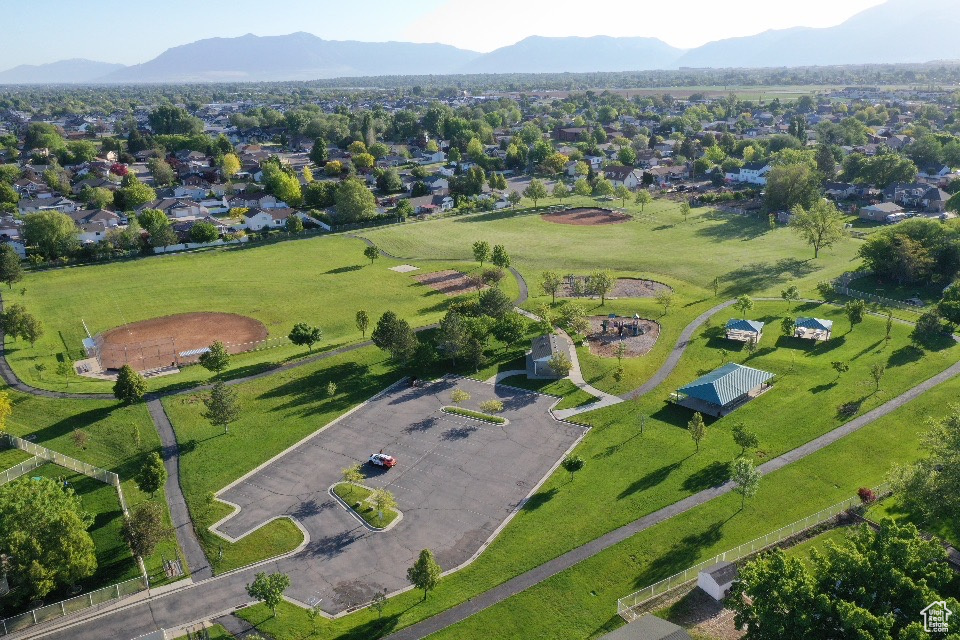 Aerial view of property and surrounding area featuring a mountainous background