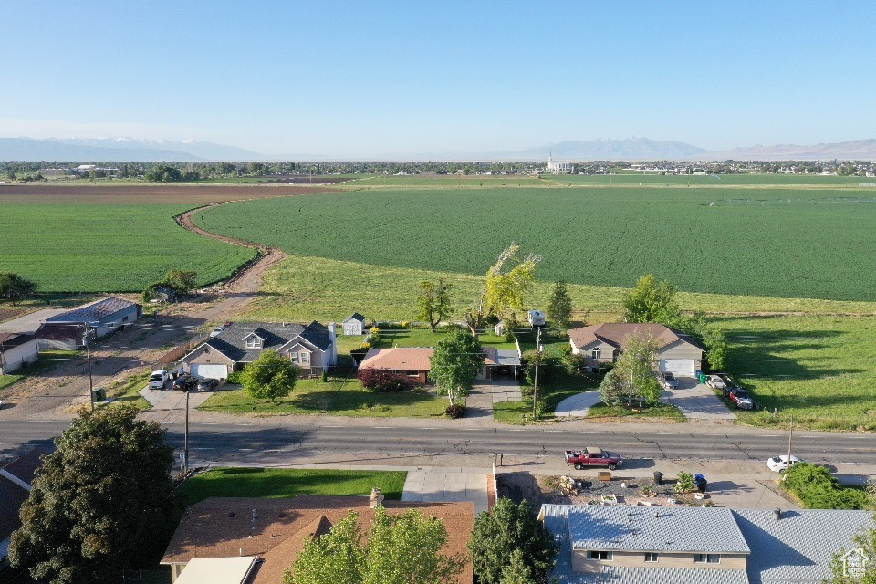 Overview of rural landscape featuring farmland and a mountainous background