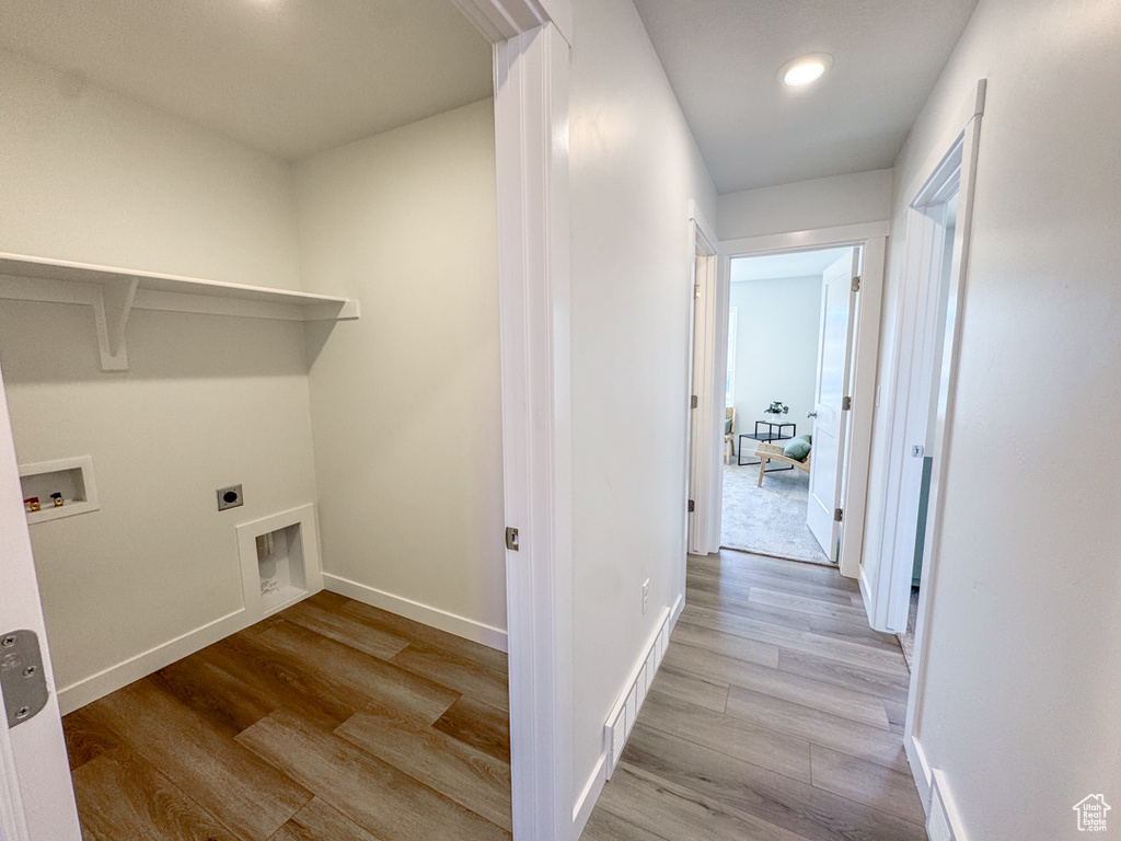 Laundry area featuring electric dryer hookup, hookup for a washing machine, wood finished floors, and recessed lighting