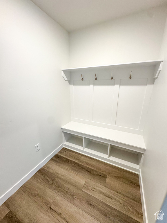 Mudroom with wood finished floors and baseboards