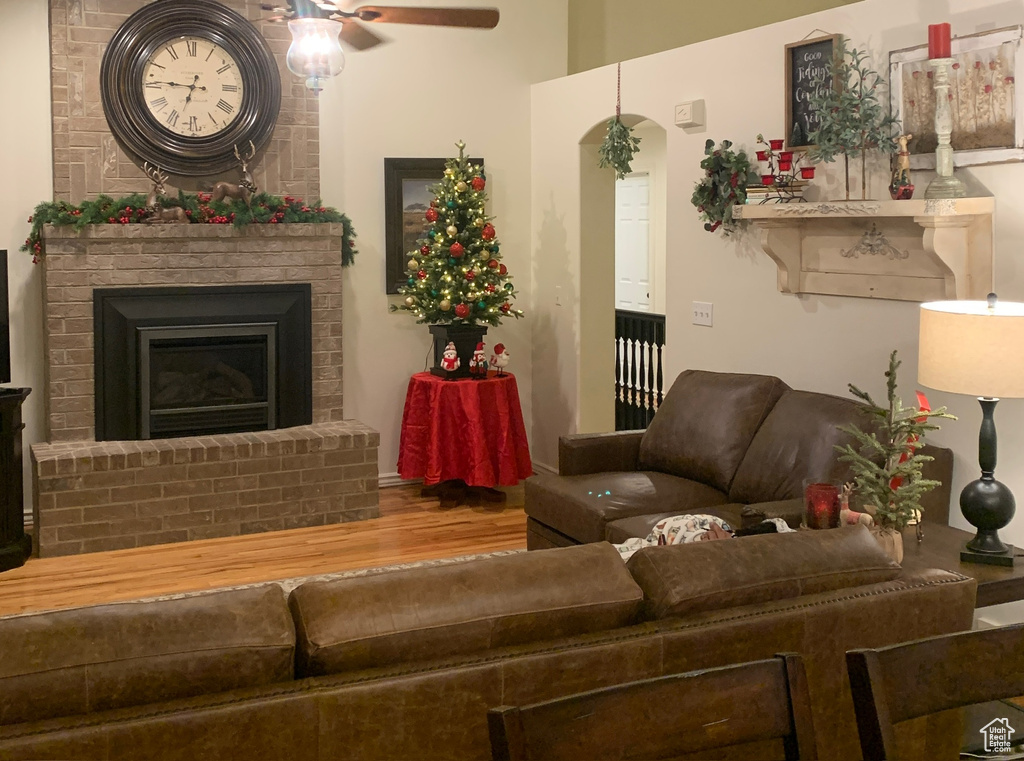 Living room with a fireplace and ceiling fan