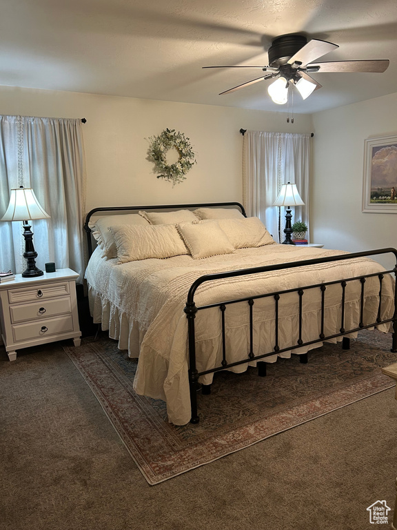 Bedroom featuring dark carpet and ceiling fan