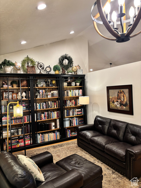 Carpeted living room featuring a chandelier and lofted ceiling