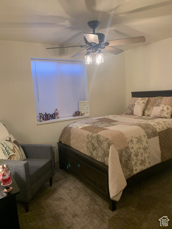 Carpeted bedroom featuring ceiling fan