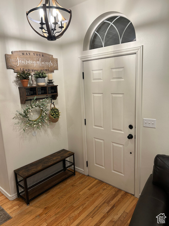 Foyer entrance featuring light hardwood / wood-style flooring and a notable chandelier