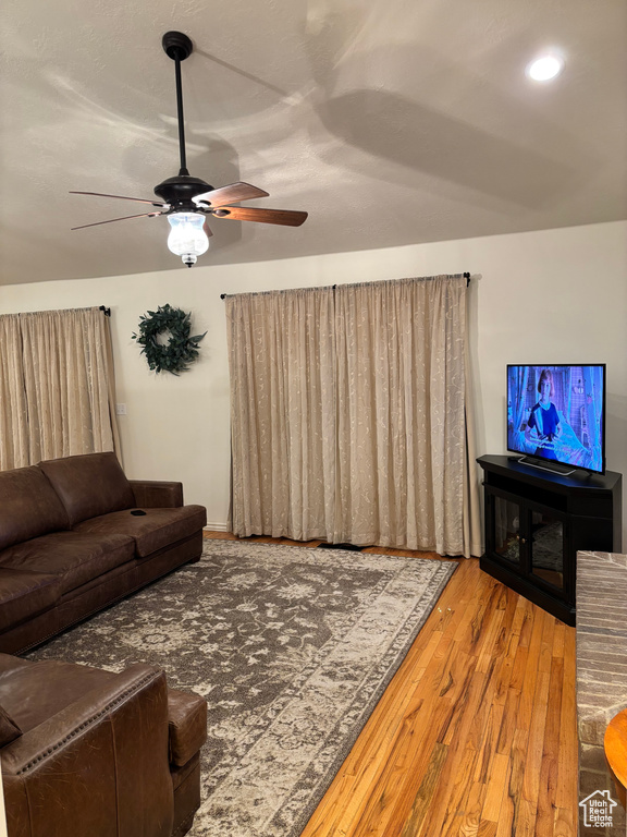 Living room featuring ceiling fan and hardwood / wood-style flooring